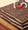 attachment-https://honeycastle.co.in/wp-content/uploads/2025/04/sq-square-shaped-choco-filled-black-forest-cake-cake2278blac-C_4-100x107.webp